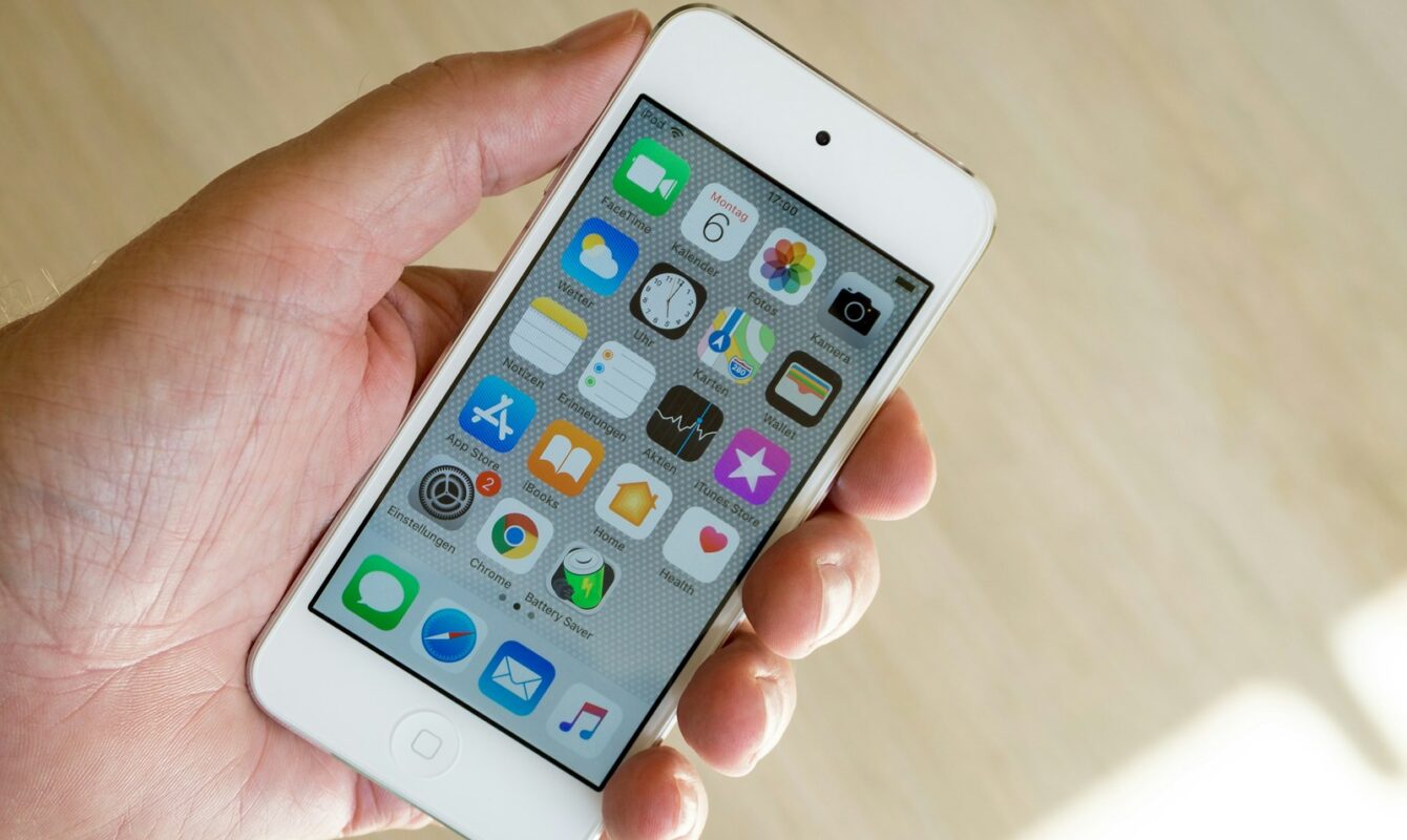 person holding white iPod touch