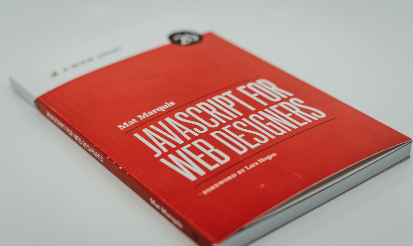 a red book sitting on top of a white table