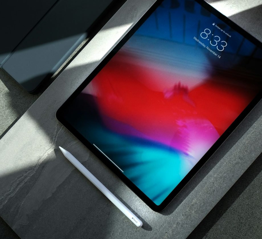 black iPad with white stylus pen