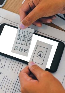 Diseño de interfaz móvil sobre wireframes impresos en papel
